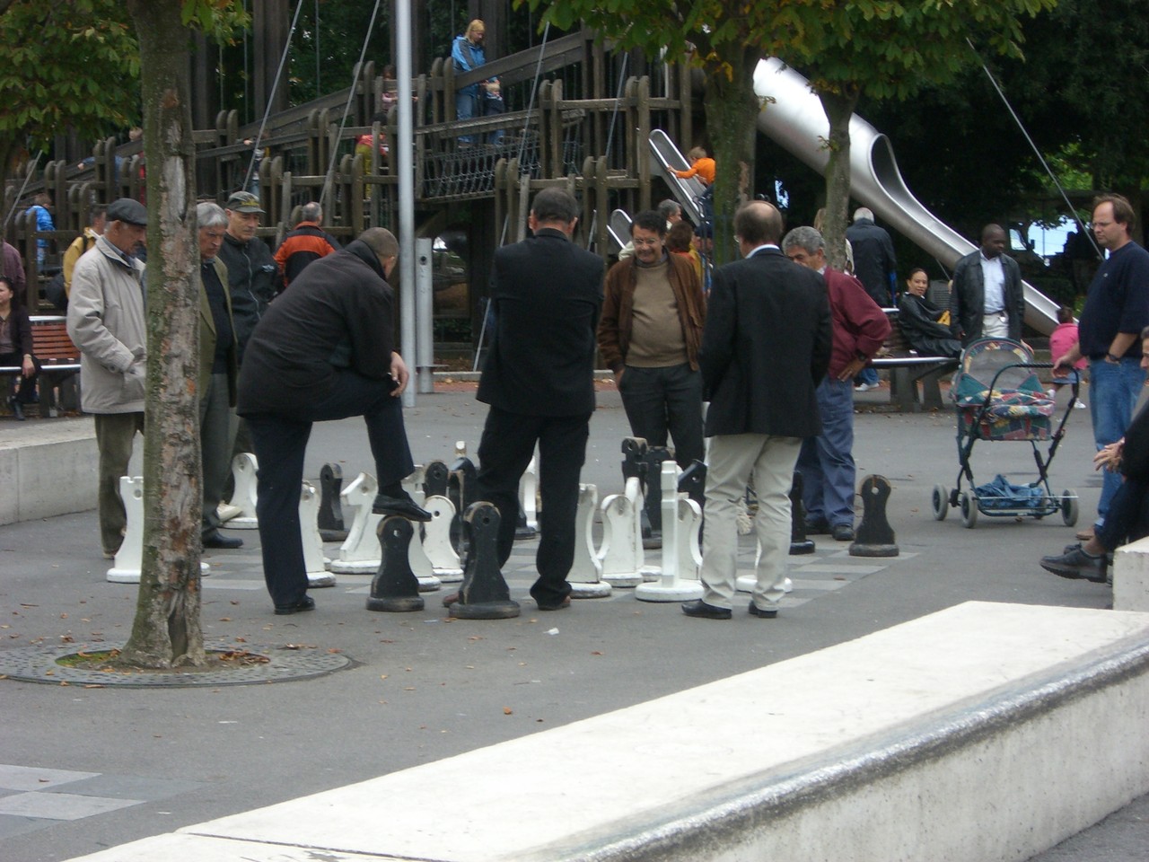 People playing chess at the harbor